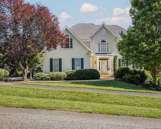 Front exterior view of 1311 Still Meadow Avenue, Charlottesville, VA 22901 – two-story home with gabled roof, manicured landscaping, and tree-lined yard.